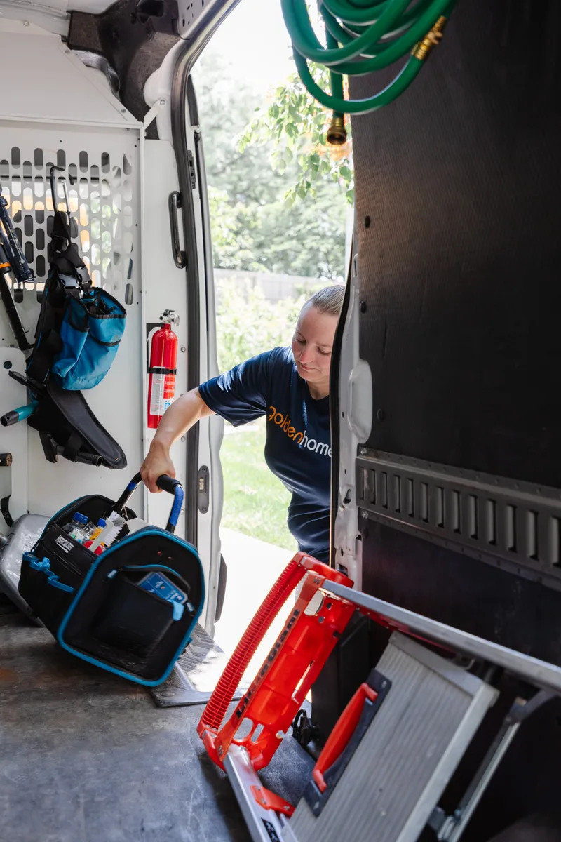 GoldenHome technician loading tools from a service van for a Topeka home visit
