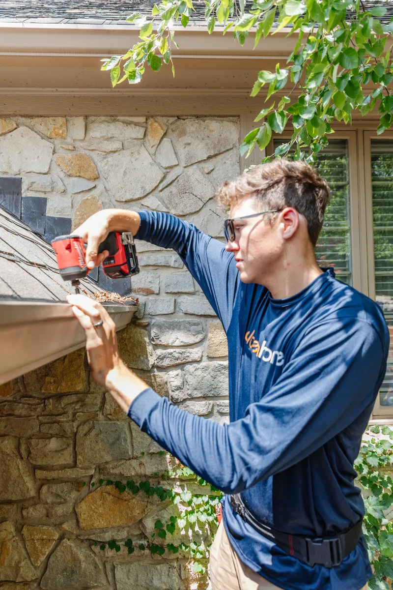 GoldenHome technician working on residential gutters and guards on a Topeka home