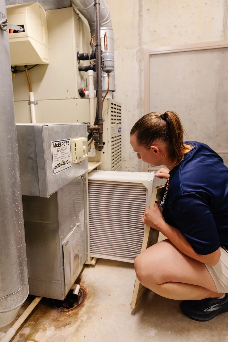 GoldenHome technician checking and replacing an HVAC air filter