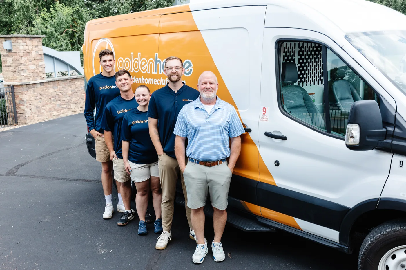 GoldenHome Club team standing together in front of a branded service van