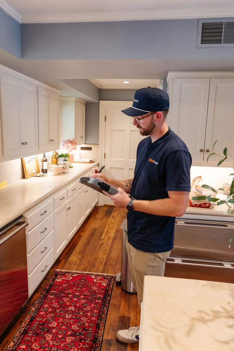 GoldenHome technician taking notes during a home walk-through